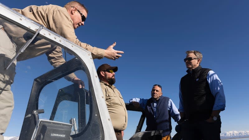 John Luft, program manager of the Great Salt Lake Ecosystem Program, and Kyle Stone, wildlife biologist for the Division of Wildlife Resources, speaks with Rep. Blake Moore and Rep. Jimmy Panetta during a tour of the Great Salt Lake in Willard on Monday, March 18, 2024.