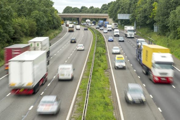 View of a busy M6 Motorway in The Midlands, traffic flowing with motion blur.