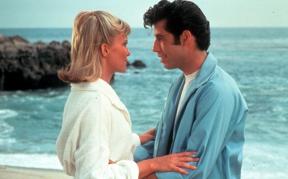 Olivia Newton-John and John Travolta embrace on the beach in a scene from the film Grease in 1978 - Paramount/Getty Images