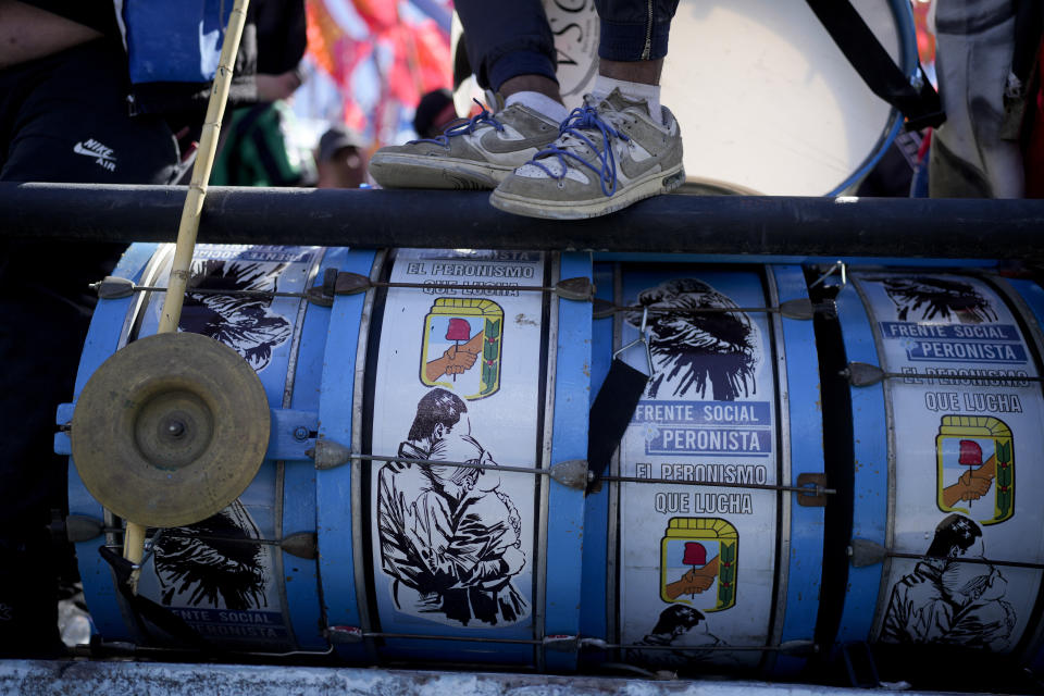 A supporter of Sergio Massa, Argentine Economy Minister and ruling party presidential candidate stands an a fence above a drum set during a campaign event in Buenos Aires, Argentina, Tuesday, Oct. 17, 2023. Argentine general elections are set for Oct. 22. (AP Photo/Natacha Pisarenko)