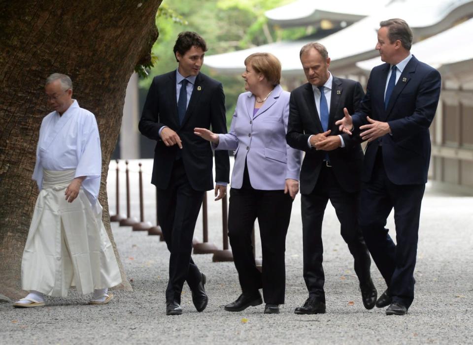 Canadian Prime Minister Justin Trudeau, second left to right, German Chancellor Angela Merkel, European Council President Donald Tusk and British Prime Minister David Cameron join fellow G7 leaders as they visit the Ise Grand Shrine (Ise Jingu) during the G7 Summit on Thursday, May 26, 2016, in Ise, Japan. (Sean Kilpatrick/The Canadian Press via AP) 