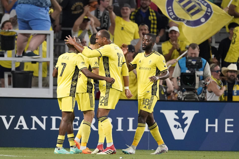 Nashville SC midfielder Fafà Picault, left, is congratulated by teammates after his goal against Inter Miami during the first half of an MLS soccer match Wednesday, May 17, 2023, in Nashville, Tenn. (AP Photo/George Walker IV)