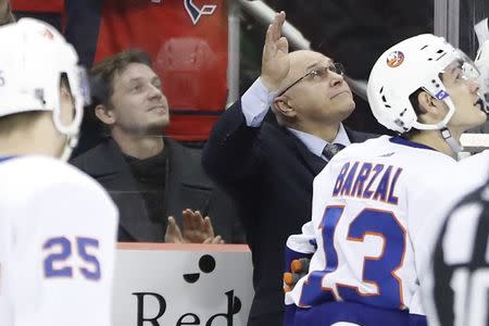 Jan 18, 2019; Washington, DC, USA; Former Washington Capitals' and current New York Islanders head coach Barry Trotz (M) waves to the crowd from the bench during a video tribute in the first period at Capital One Arena. The Islanders won 2-0. Mandatory Credit: Geoff Burke-USA TODAY Sports