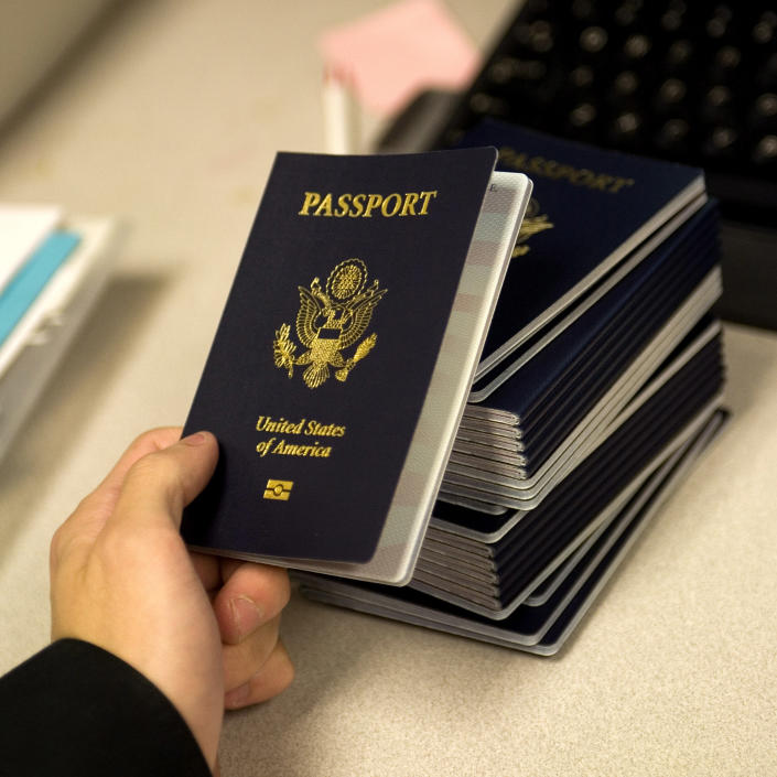 A government official holds a new blank U.S. passport 