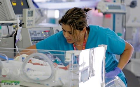 A nurse attends to an infant in the neonatal intensive care unit - Credit: JOE SKIPPER