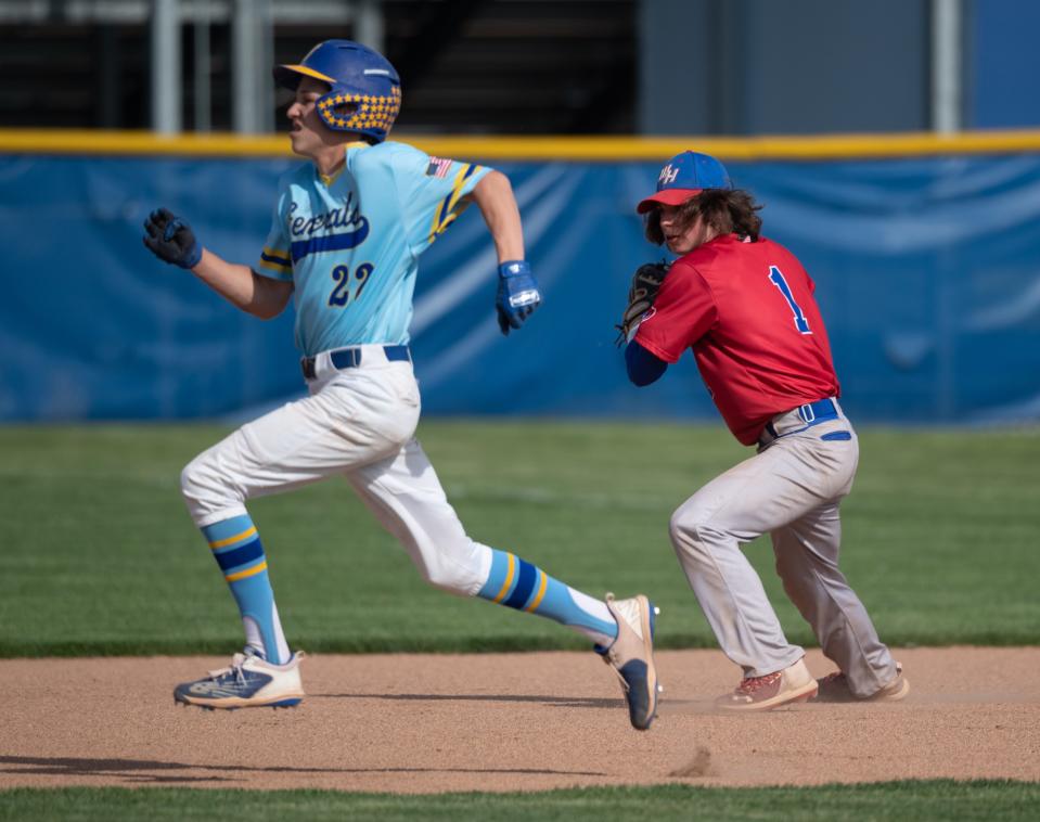 West Holmes' second baseman Gino DiNardi turns to throw out Wooster's Brady Bowen.