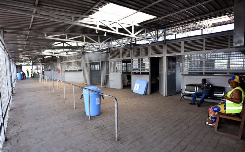 Health and customs officials sit at a deserted crossing point between the Democratic Republic of Congo and Rwanda amid concerns about the spread of coronavirus disease (COVID-19), at the Petite Barriere in Goma