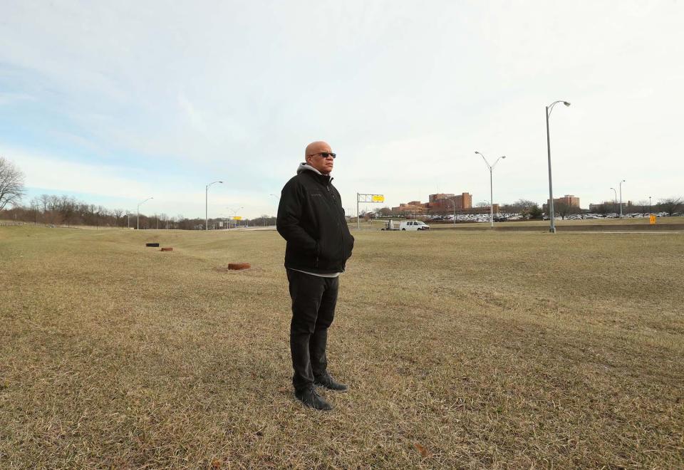 The Rev. Greg Harrison stands on the spot where his family used to rent on 636 Douglas St. The family had to move because of the Akron Innerbelt construction. The home was destroyed along with hundreds of other surrounding houses and businesses.