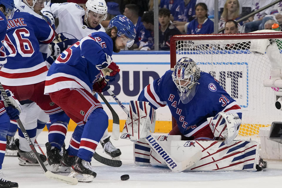 New York Rangers goaltender Igor Shesterkin (31) makes a save in the second period of Game 2 of the NHL hockey Stanley Cup playoffs Eastern Conference finals against the Tampa Bay Lightning, Friday, June 3, 2022, in New York. (AP Photo/John Minchillo)