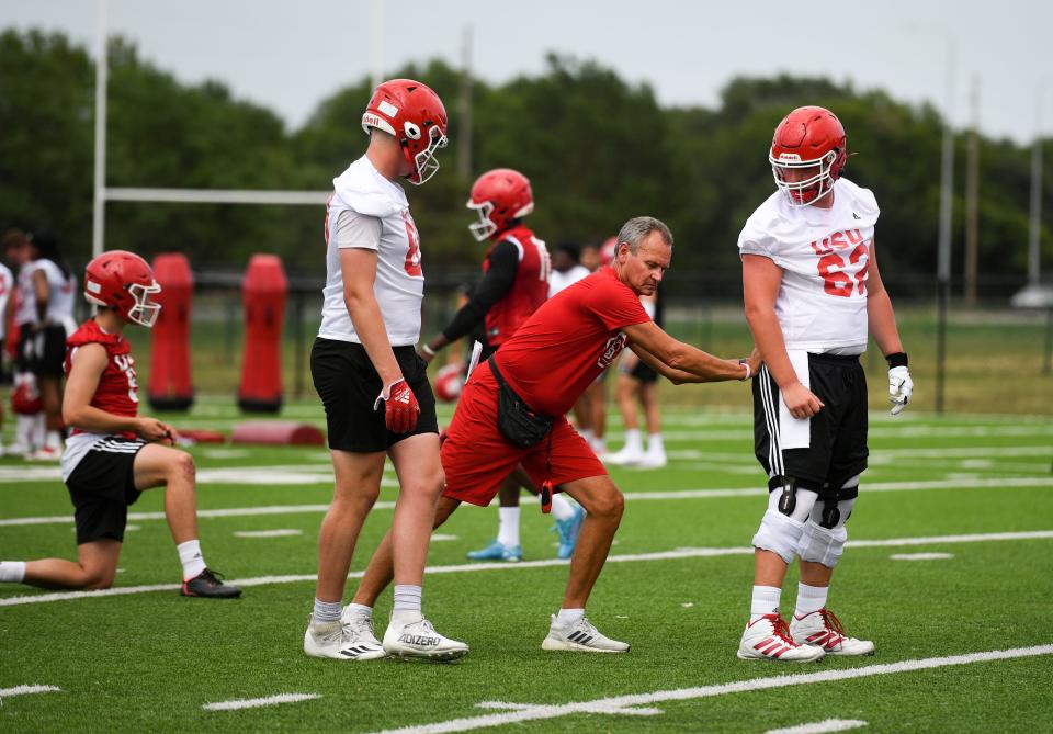 University of South Dakota football head coach Bob Nielson instructs players during drills at the first practice of the season on Thursday, August 4, 2022, in Vermillion.