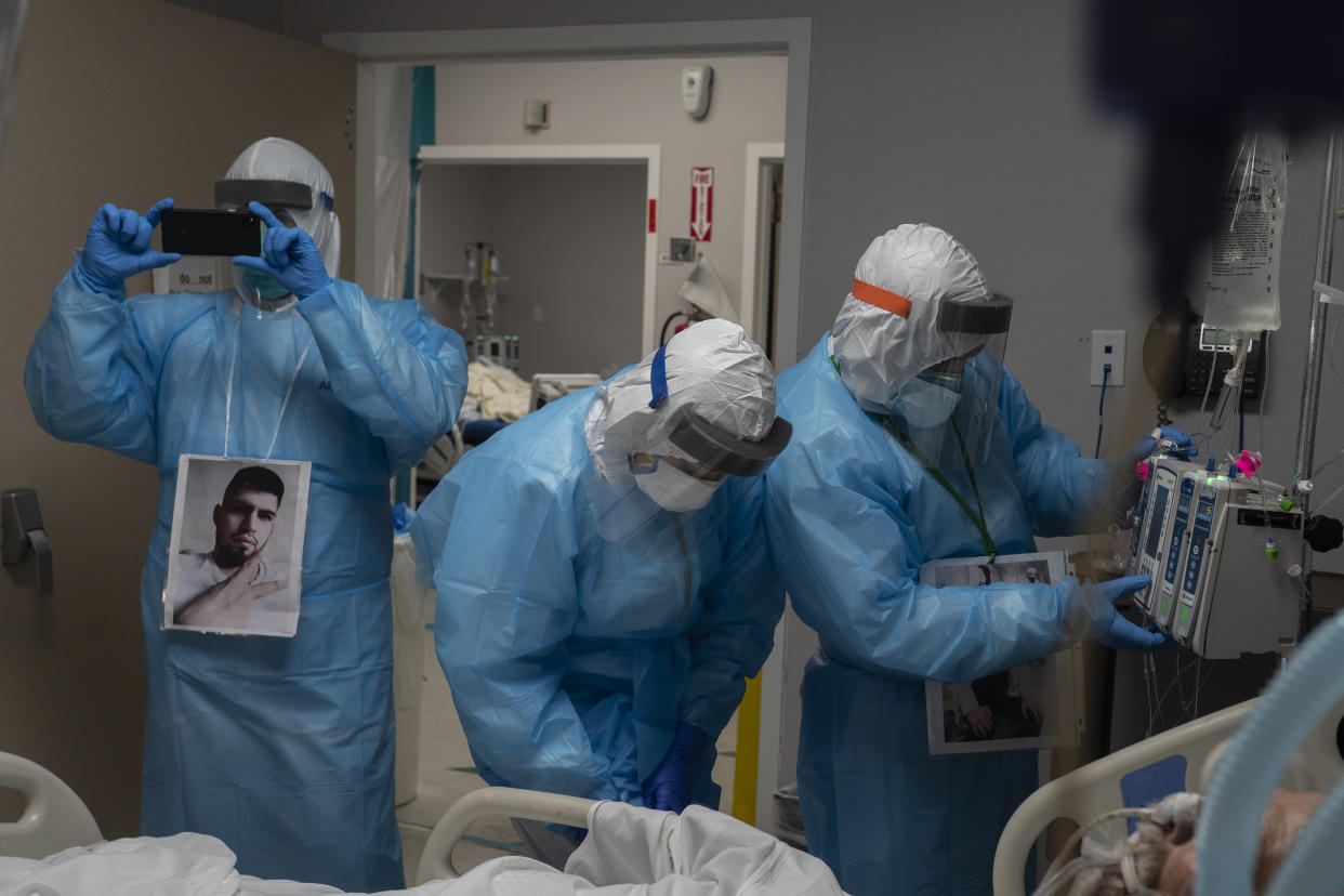 Medical staff members examine a patient suffering from the coronavirus disease (COVID-19) in the COVID-19 intensive care unit (ICU) at the United Memorial Medical Center on November 22, 2020 in Houston, Texas. (Photo by Go Nakamura/Getty Images)