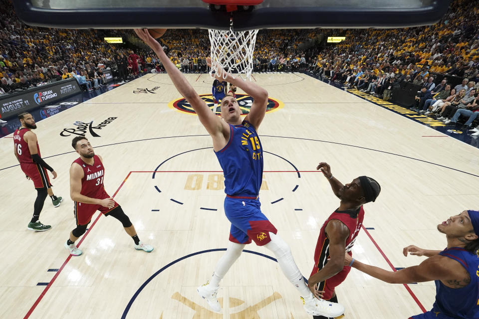 Denver Nuggets center Nikola Jokic, center, shoots against the Miami Heat during the first half of Game 1 of basketball's NBA Finals, Thursday, June 1, 2023, in Denver. (Kyle Terada/Pool Photo via AP)