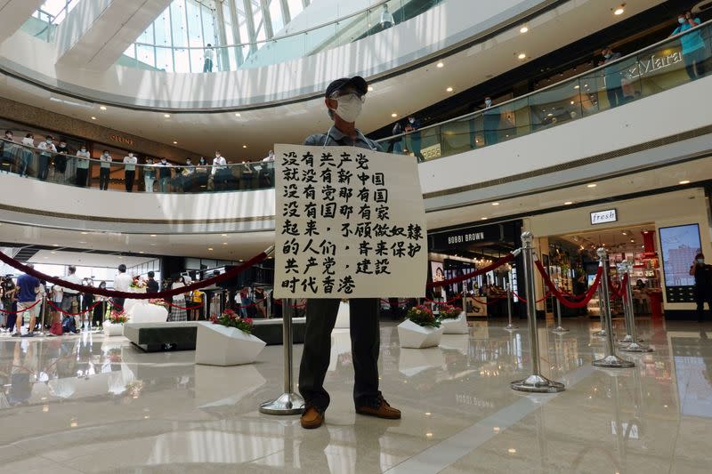 FILE PHOTO: Pro-democracy demonstrator takes part in a lunchtime protest against the national security law, at a shopping mall in Hong Kong