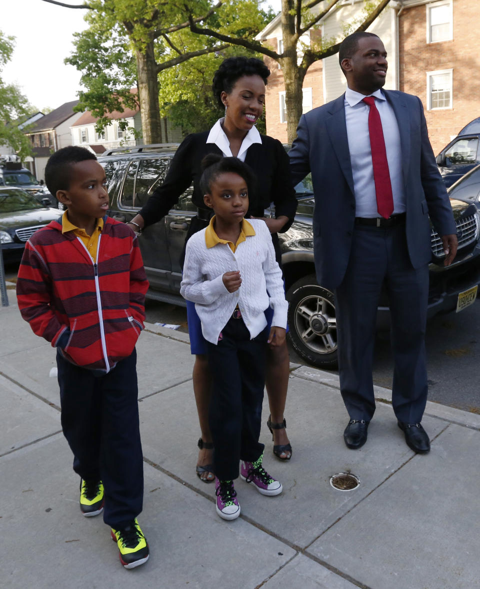 Newark mayoral candidate Shavar Jeffries, right, walks with his wife, Tenagne Girma-Jeffries, and their children, Kaleb Jeffries, 9, left, and Naomi Jeffries as they arrive at a polling place, Tuesday, May 13, 2014, in Newark, N.J. Tuesday's election will decide whether Jeffries, a former state assistant attorney general, or his opponent, City Councilman Ras Baraka, will take over the seat Cory Booker occupied from 2006 until October 2013, when he won a special election to succeed U.S. Sen. Frank Lautenberg, who died in office. (AP Photo)