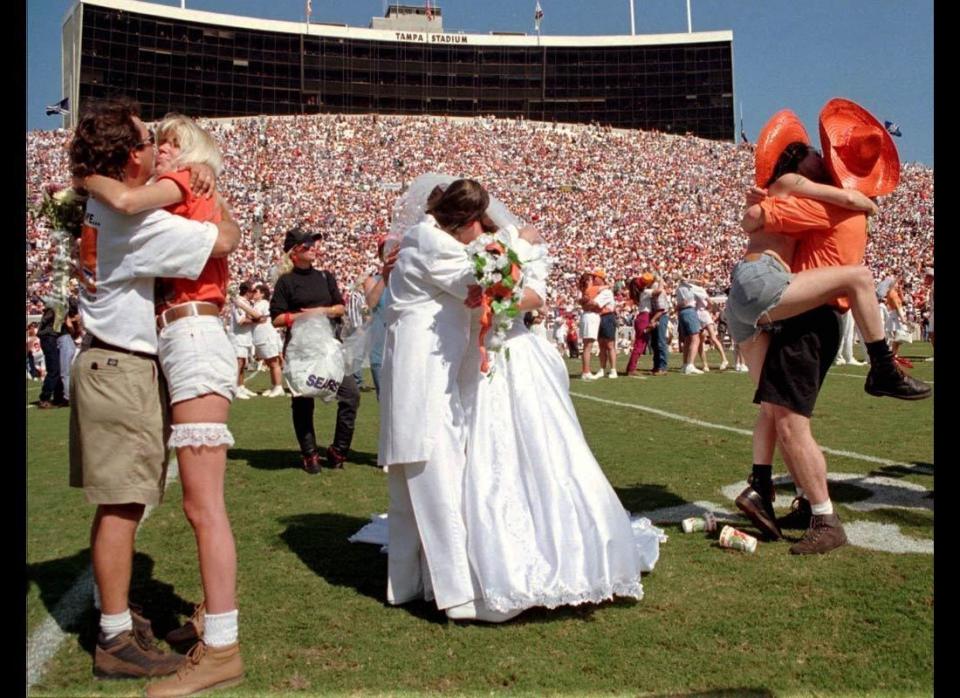 What better way to tackle marriage head-on than to get hitched during a football game? On Oct. 22, 1995, a mass wedding was held for 200 couples during halftime of a game between the Tampa Bay Buccaneers and the Atlanta Falcons. Billed as the largest wedding in NFL history, the couples wore anything and everything to their big day -- from traditional formal wedding attire to more casual garments such as cut-off jean shorts and sombreros. 