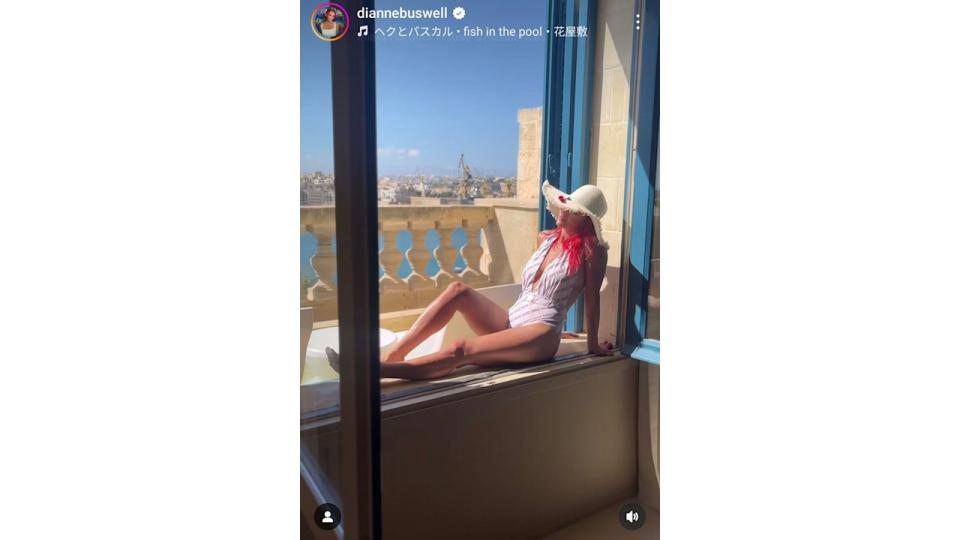 woman wearing swimsuit whilst sitting on balcony