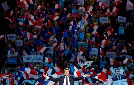 Emmanuel Macron, head of the political movement En Marche !, or Onwards !, and candidate for the 2017 French presidential election, attends a campaign political rally at the AccorHotels Arena in Paris, France, April 17, 2017. REUTERS/Christian Hartmann