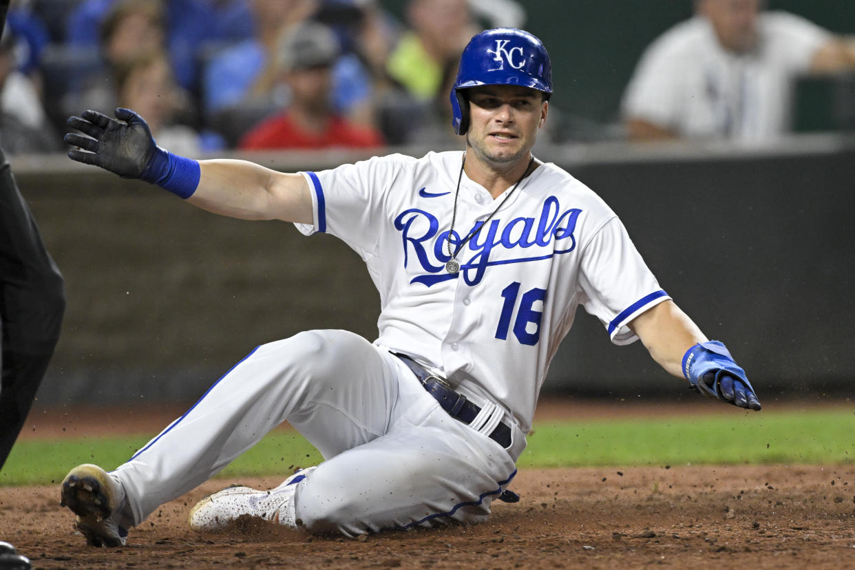Kansas City Royals' Andrew Benintendi slides across home plate to score against the Detroit Tigers during the eighth inning of a baseball game, Tuesday, July 12, 2022, in Kansas City, Mo. (AP Photo/Reed Hoffmann)