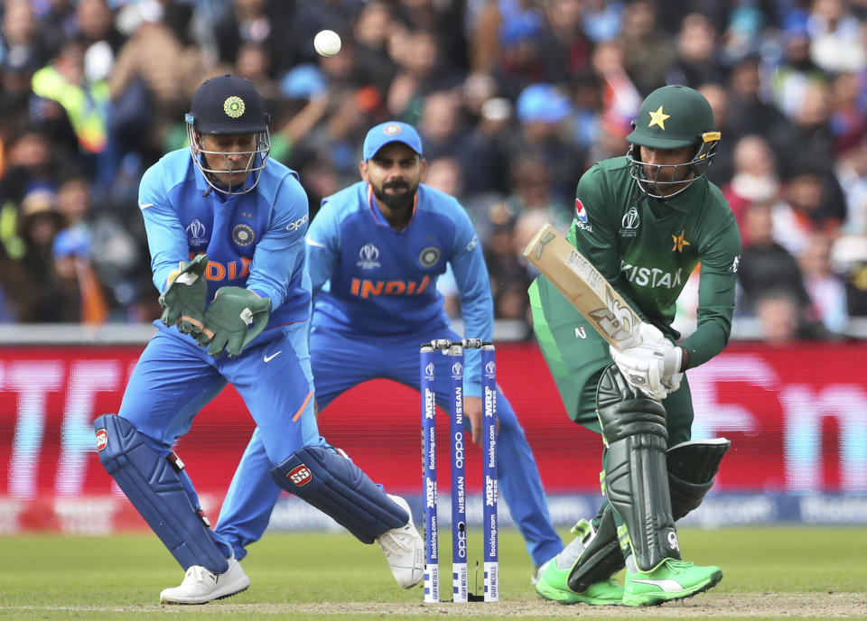 Pakistan's Fakhar Zaman, right, plays a shot during the Cricket World Cup match between India and Pakistan at Old Trafford in Manchester, England, Sunday, June 16, 2019. (AP Photo/Aijaz Rahi)