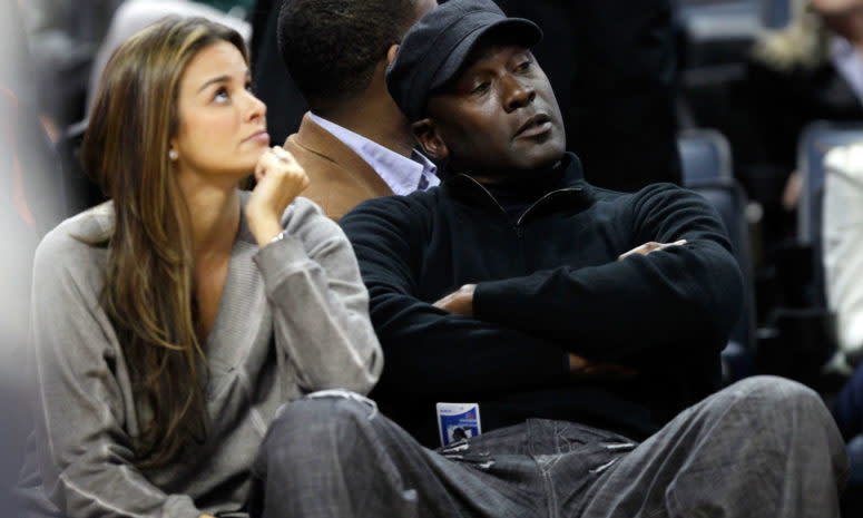 Michael Jordan and his wife sitting courtside.