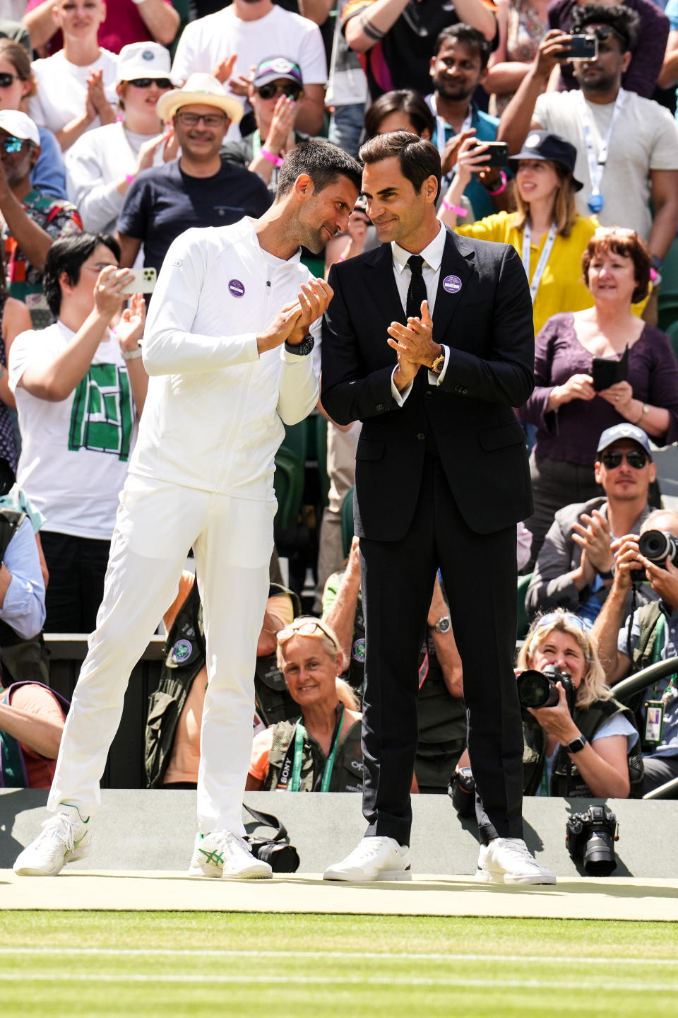 Novak Djokovic (pictured left) shared a laugh with Roger Federer (pictured right) during a Wimbledon celebration of champions.