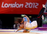 Japan's Saori Yoshida celebrates her victory over Canada's Tonya Lynn Verbeek on the final of the Women's 55Kg Freestyle wrestling at the ExCel venue during the London 2012 Olympic Games August 9, 2012. REUTERS/Grigory Dukor (BRITAIN - Tags: OLYMPICS SPORT WRESTLING TPX IMAGES OF THE DAY) 