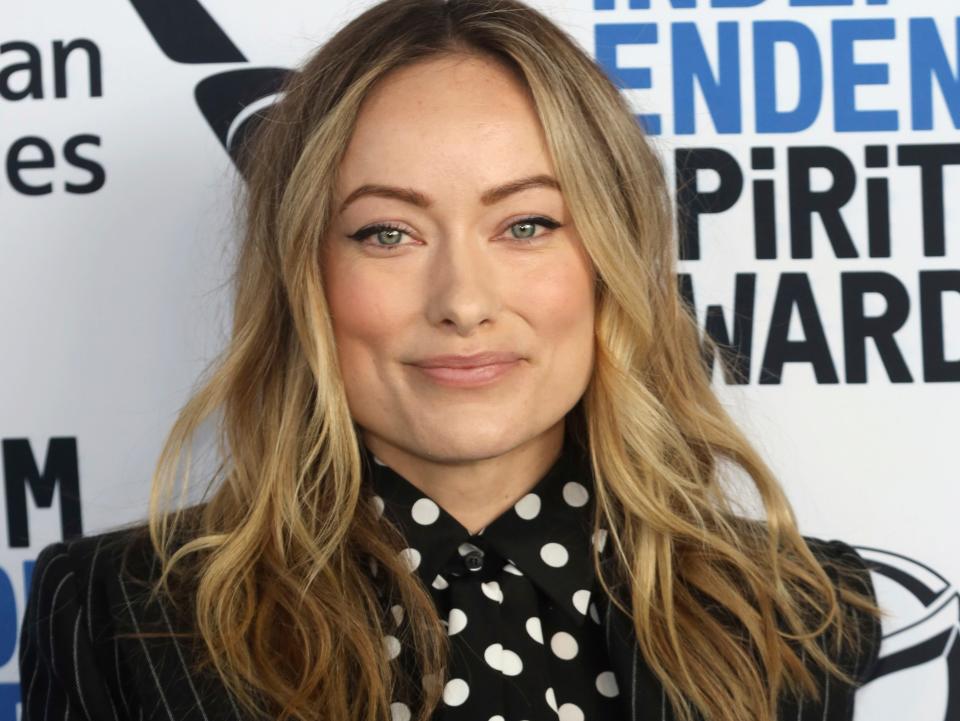 Olivia Wilde wearing a polka dot blouse and striped blazer in January 2020.