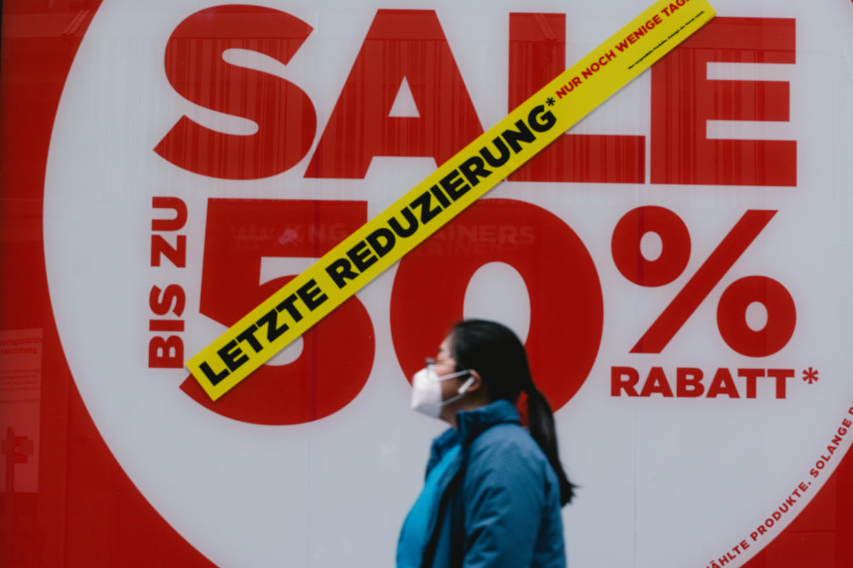 a woman walks pass a big 50 percent sale sign in a retailer store  amid the Coronavirus lockdown in Cologne (Photo by Ying Tang/NurPhoto via Getty Images)