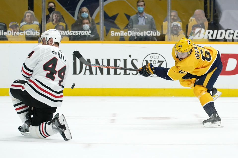 Chicago Blackhawks defenseman Calvin de Haan (44) blocks a shot by Nashville Predators center Mikael Granlund (64) in the second period of an NHL hockey game Tuesday, Jan. 26, 2021, in Nashville, Tenn. (AP Photo/Mark Humphrey)