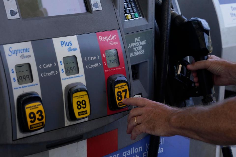 A customer pumps gas at an Exxon gas station, Tuesday, May 10, 2022, in Miami. Gasoline prices are sliding back toward the $4 mark for the first time in more than five months — good news for consumers who are struggling with high prices for many other essentials. (AP Photo/Marta Lavandier) ORG XMIT: BKWS302