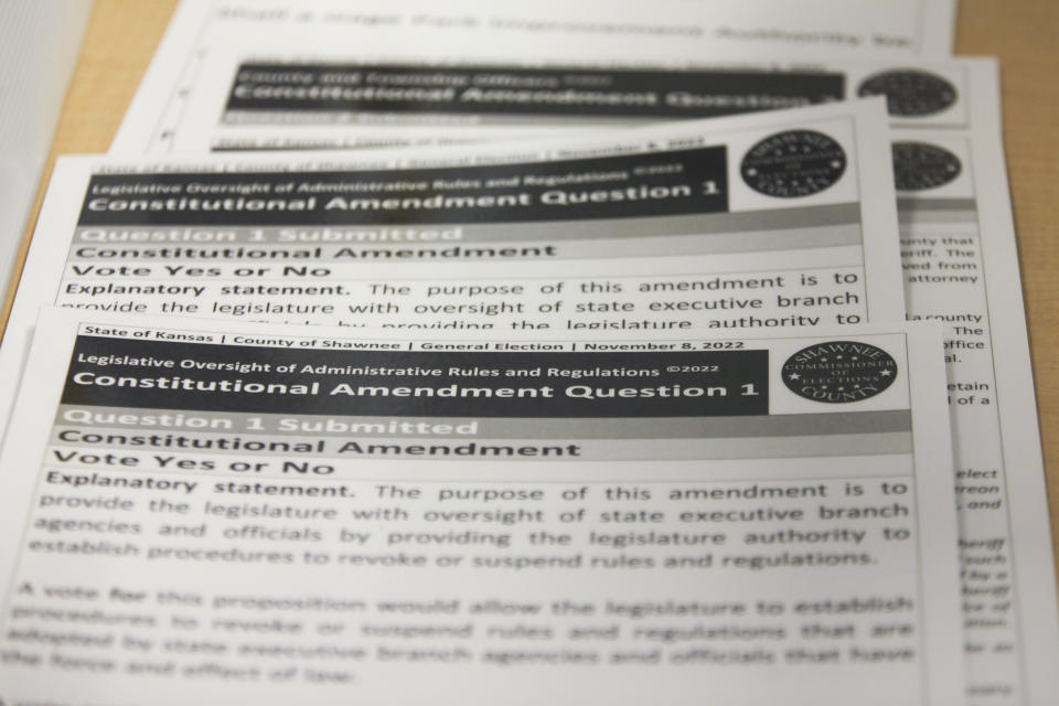 Sample ballots for a proposed amendment to the Kansas Constitution rest on a table in the Shawnee County Election Office, Tuesday, Oct. 25, 2022, in Topeka, Kan. The proposed amendment would make it easier for the Legislature to overturn agency rules. (AP Photo/John Hanna)