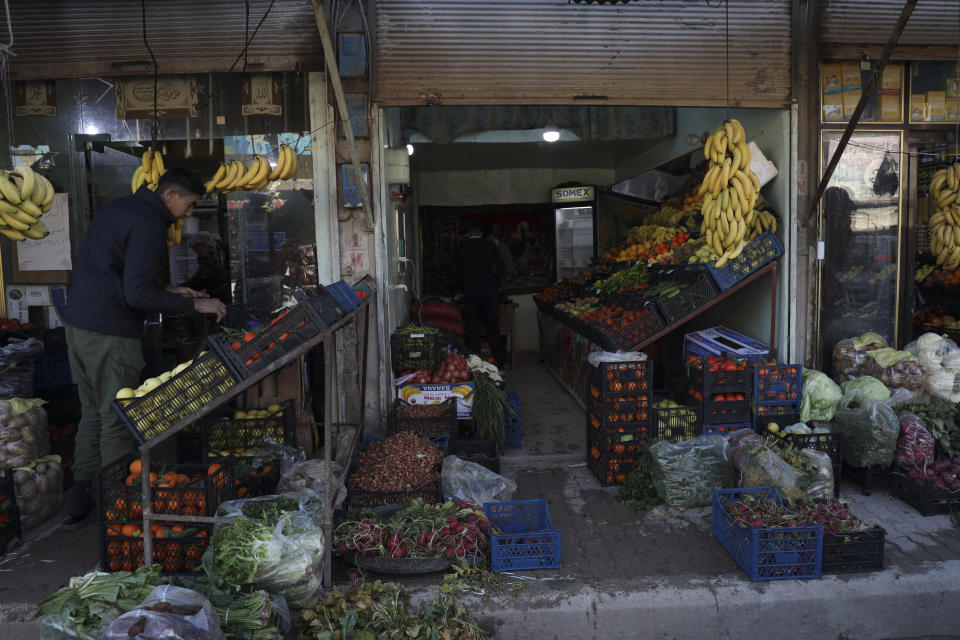 A man buys vegetables in Jinderis, Syria, on Jan. 27, 2024, a year after the area was hit by a devastating earthquake. (AP Photo/Omar Albam)