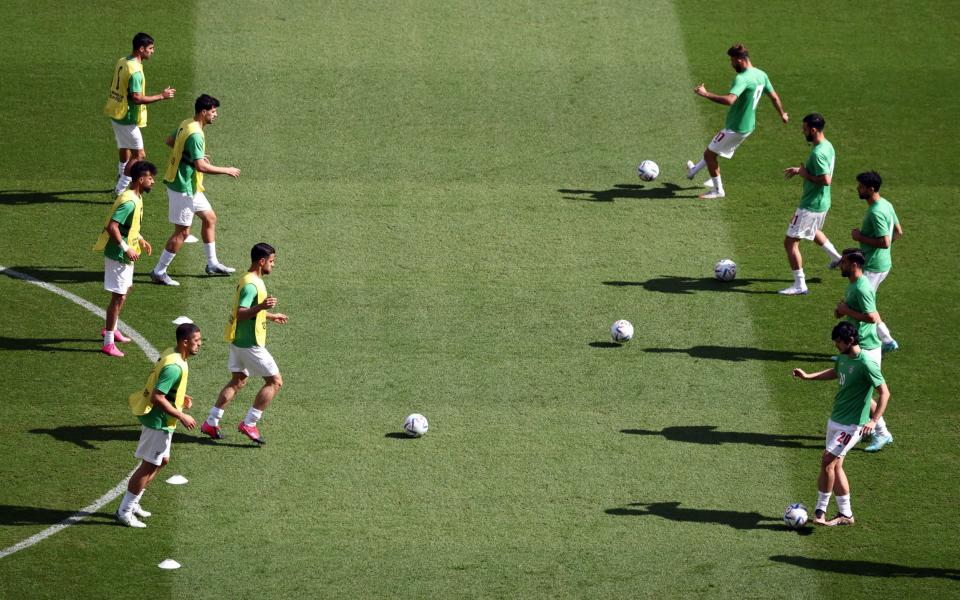 Iran players during the warm up before the match - Reuters