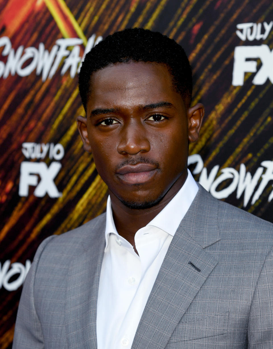 Damson Idris poses on the red carpet of a Snowfall premiere