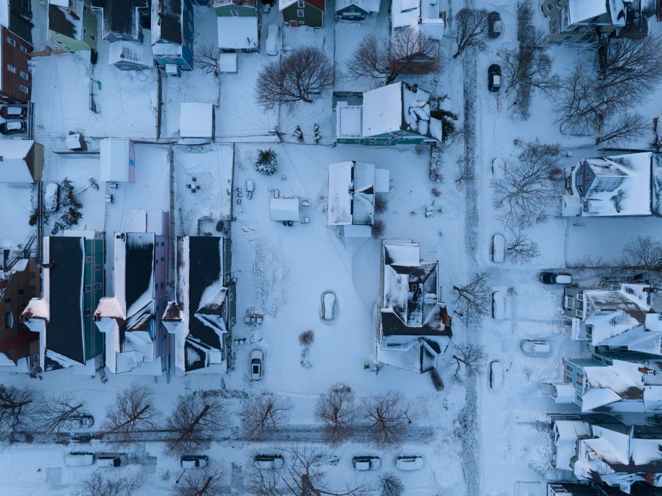 In this aerial photo, cars are still buried in the blizzards snow in Buffalo, New York, on December 28, 2022. - The monster storm that killed dozens in the US over the Christmas weekend continued to inflict misery on New York state and air travelers nationwide, as stories emerged of families trapped for days during the 
