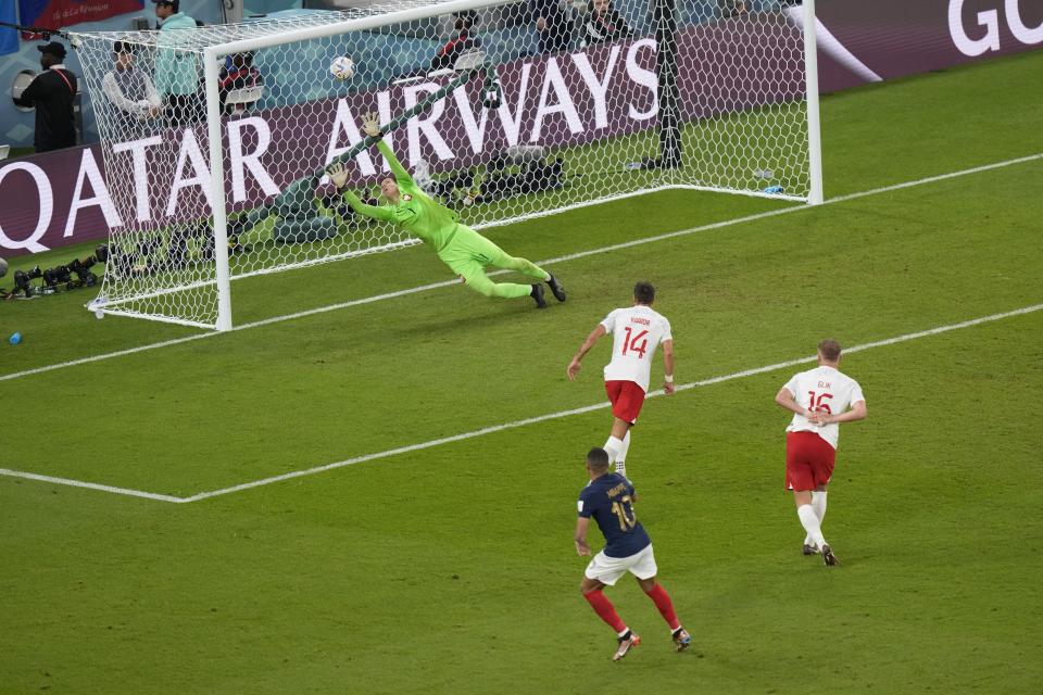 France's Kylian Mbappe, right, fights for the ball with Poland's Matty Cash, during the World Cup round of 16 soccer match between France and Poland, at the Al Thumama Stadium in Doha, Qatar, Sunday, Dec. 4, 2022. (AP Photo/Luca Bruno)