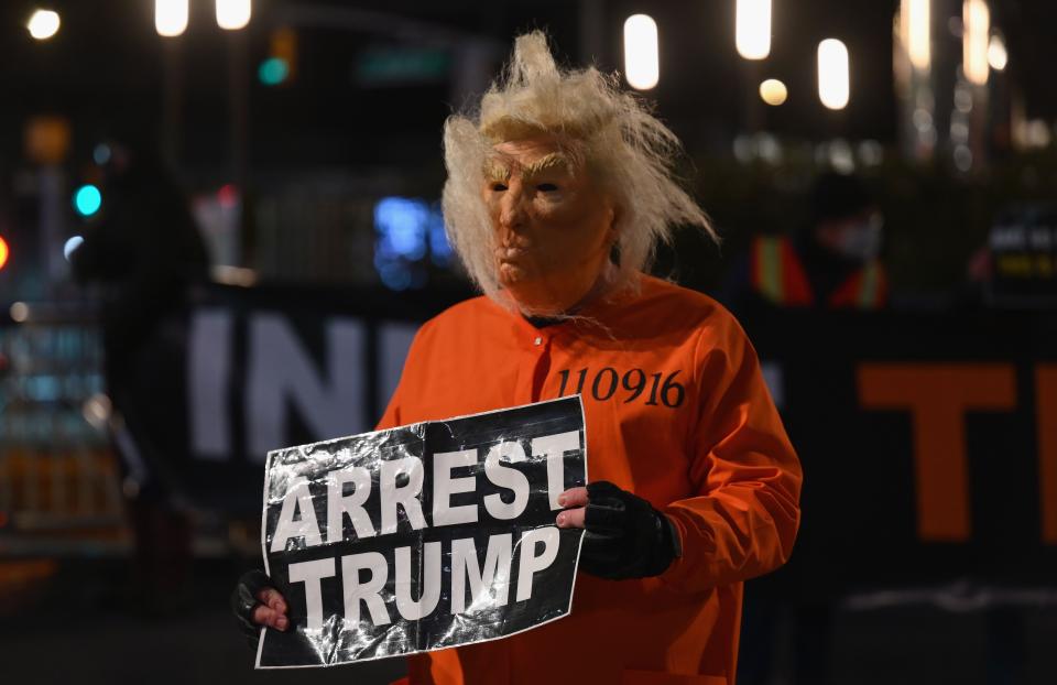 A man dressed as Trump in a prison jump suit protests in front of Trump International Hotel & Tower in New York on Jan. 6, 2021.