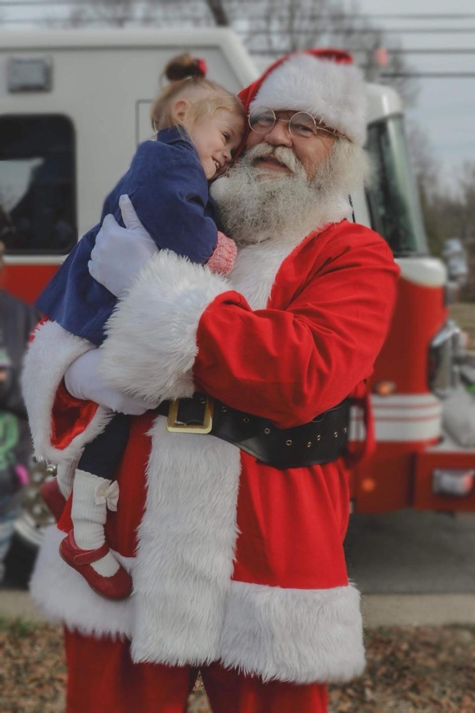 Ranlo girl Isla hugs Santa Claus at an event Dec. 16, 2023