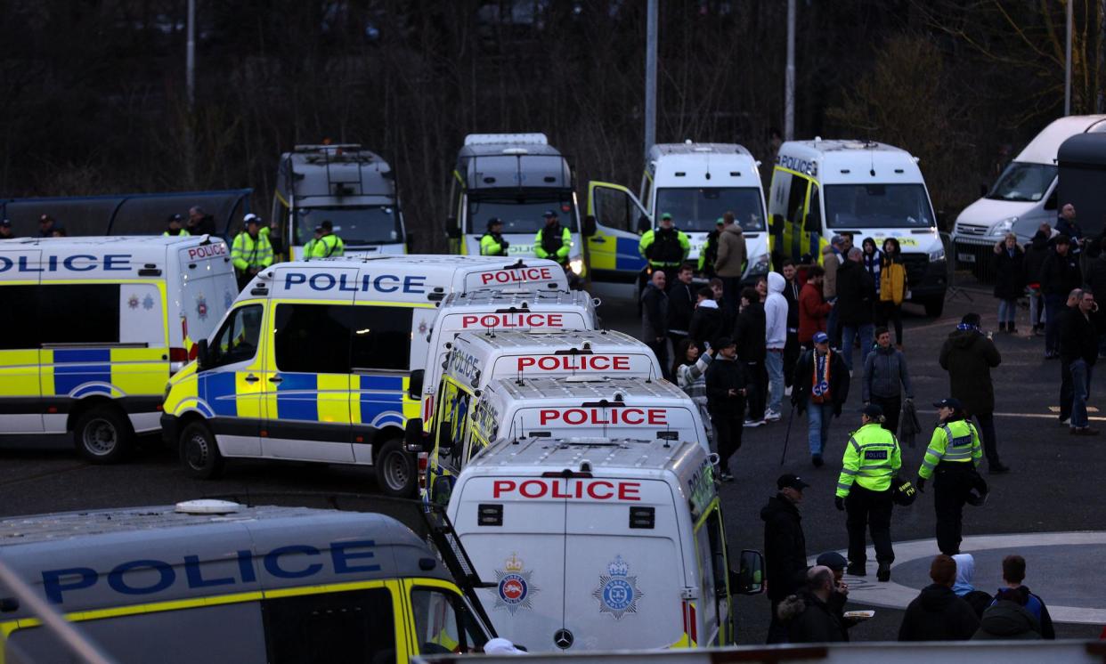 <span>Diverting police officers to football matches and festivals means specialist investigators sometimes have to cancel appointments with victims of crime and delay making arrests.</span><span>Photograph: Adrian Dennis/AFP/Getty Images</span>