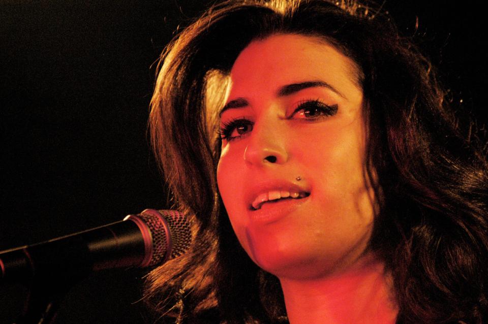 Amy Winehouse at the Barfly Club in Cardiff, Wales on 2 March 2004. This was a charity gig for about 100 people at a tiny club and the young 20-year-old singer was touring with songs from her debut album 'Frank'. Photograph: ROB WATKINS