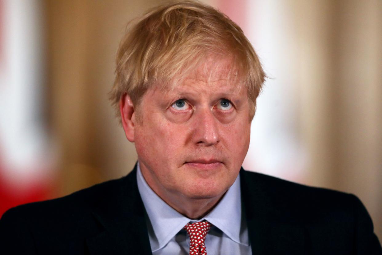 Britain's Prime Minister Boris Johnson listens at a news conference addressing the government's response to the novel coronavirus COVID-19 outbreak, at 10 Downing Street in London on March 12, 2020. - Britain on Thursday said up to 10,000 people in the UK could be infected with the novel coronavirus COVID-19, as it announced new measures to slow the spread of the pandemic. (Photo by SIMON DAWSON / POOL / AFP) (Photo by SIMON DAWSON/POOL/AFP via Getty Images)