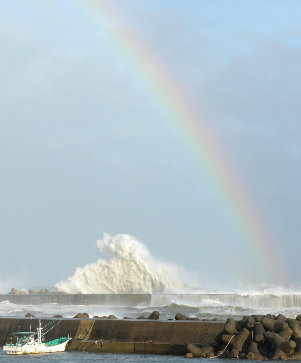 A rainbow appears while high waves hit a breakwater in Kihocho, Mie prefecture, western Japan Sunday, Sept. 30, 2012. A powerful typhoon is heading to Tokyo after injuring dozens of people, causing blackouts and paralyzing traffic in southern Japan. (AP Photo/Kyodo News) JAPAN OUT, MANDATORY CREDIT, NO LICENSING IN CHINA, FRANCE, HONG KONG, JAPAN AND SOUTH KOREA