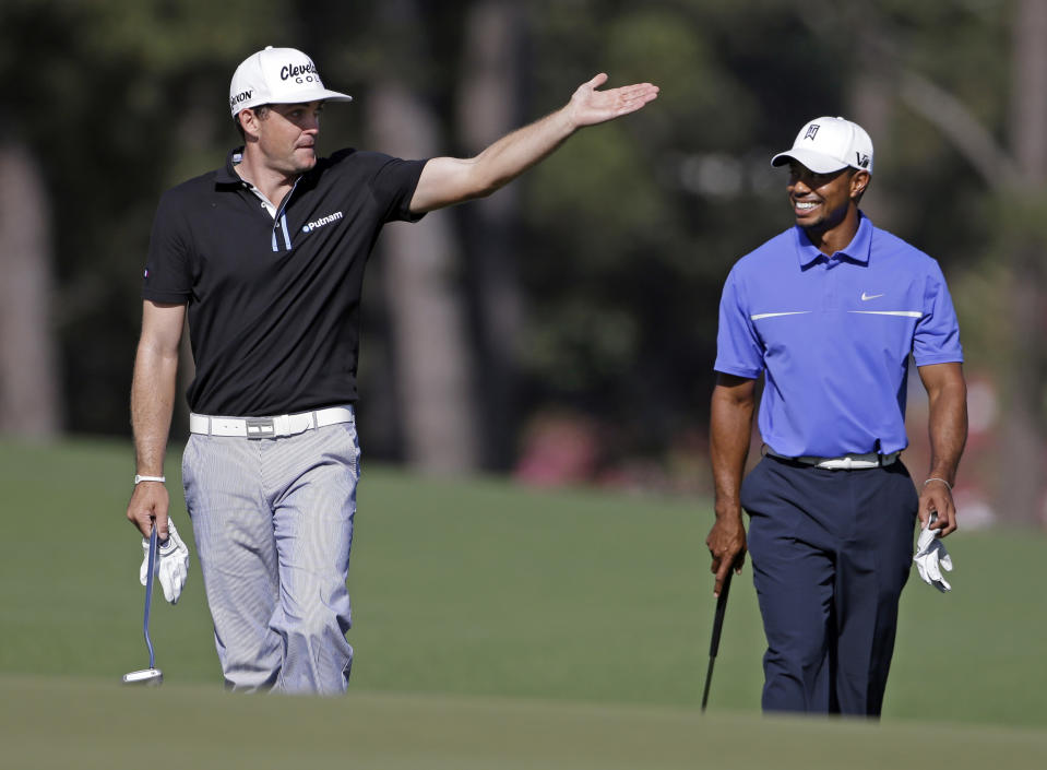 Keegan Bradley, left, talks to Tiger Woods on the 17th fairway during a practice round for the Masters.