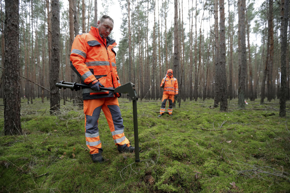 In this Wednesday, Jan. 8, 2020 photo members of a bomb disposal team search for World War II munition at the site of the planned new Tesla Gigafactory in Gruenheide near Berlin, Germany. Tesla CEO Elon Musk said during an awards ceremony in Berlin in November 2019 that 'we have decided to put the Tesla Gigafactory Europe in the Berlin area.' The company will also set up an engineering and design center in Berlin, Musk said. He wrote on Twitter that the new plant 'will build batteries, powertrains & vehicles, starting with Model Y.' (AP Photo/Michael Sohn)