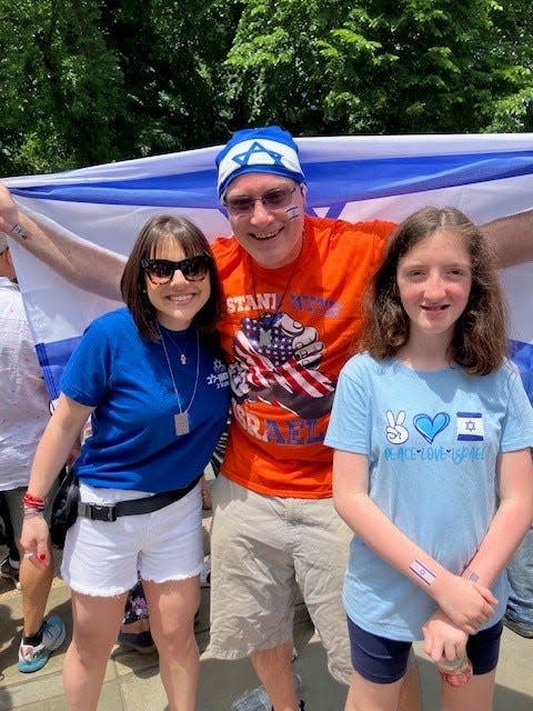 Michael Saratovsky of Rockaway Beach, with his daughter Kaylee, right, and his friend Elana Stern from New York at Israel Day on Fifth on Sunday, June 2, 2024.