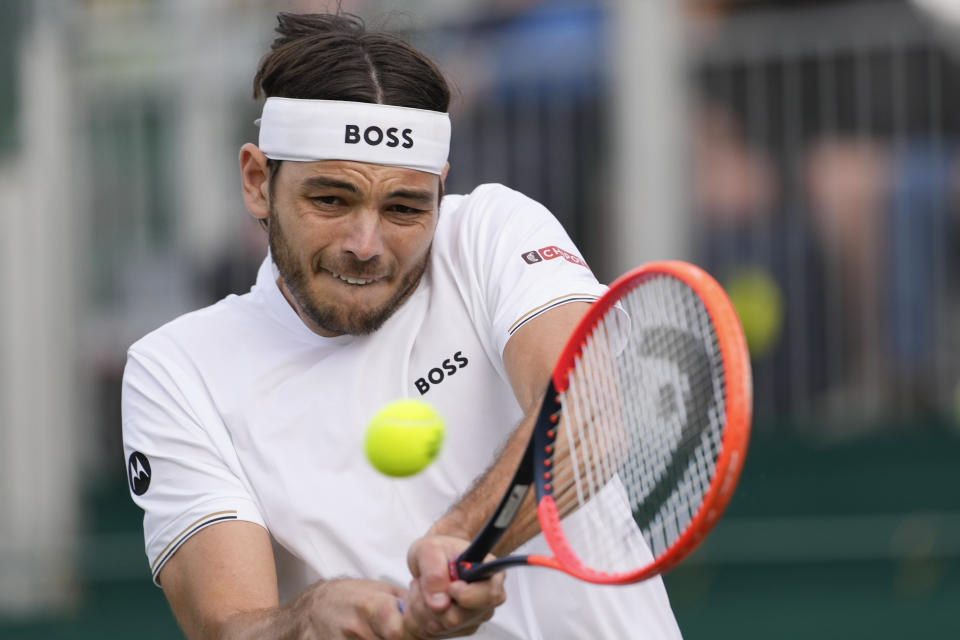 Taylor Fritz of the United States plays a backhand return to Arthur Rinderknech of France during their second round match at the Wimbledon tennis championships in London, Thursday, July 4, 2024. (AP Photo/Alberto Pezzali)