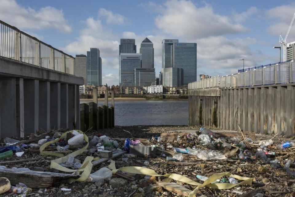 Plastic gathers on the edge of the Thames near Canary Wharf (Getty Images)