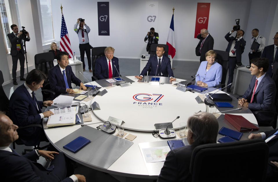 FILE - Aug.26 2019, file photo, from the left, Italian Prime Minister, Giuseppe Conte, Japanese Prime Minister Shinzo Abe, U.S President Donald Trump, French President Emmanuel Macron, German Chancellor Angela Merkel, Canadian Prime Minister Justin Trudeau, Britain's Prime Minister Boris Johnson attend a work session during the G7 summit at Casino in Biarritz, southwestern France. President Donald Trump starts the new year knee-deep in daunting foreign policy challenges at the same time he'll have to deal with a likely impeachment trial in the Senate and the demands of a reelection campaign. (Ian Langsdon, Pool via AP, File)