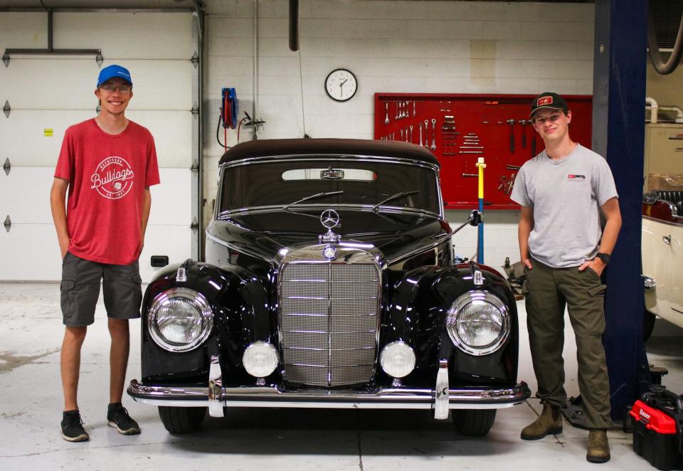 McPherson College Seniors James Pawlak (left) and Jeremy Porter (right) stand next to a 1953 Mercedes-Benz 300S Cabriolet that the two helped restore. The car secured second in class at the 72nd Pebble Beach Concours d'Elegance.