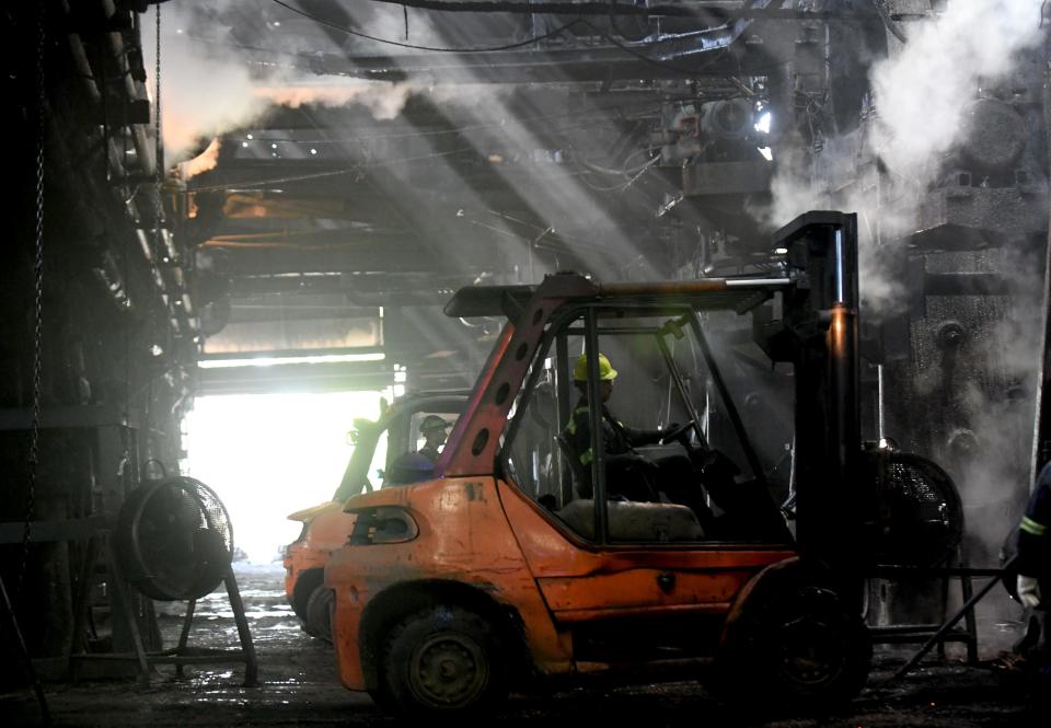 Workers at the Canton Drop Forge factory in Perry Township prepare a hammer to forge steel parts. The company is adding equipment and employees.